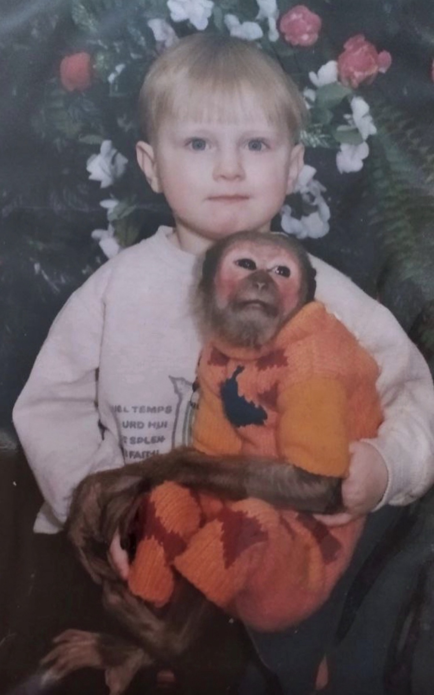 A childhood photo of me in Belarus holding a monkey.